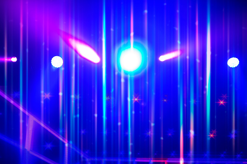 Bright multi-colored iridescent lights of stage lighting. Background scene, performance. Concert light.