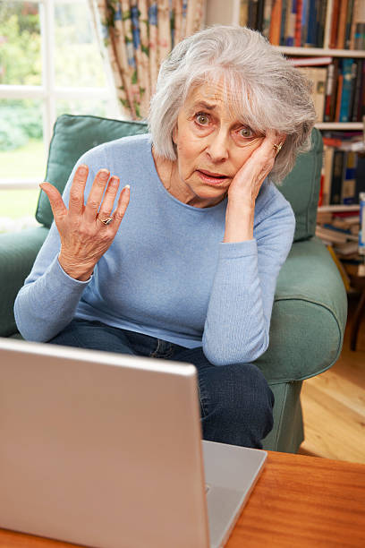istock Frustrated Senior Woman Tring To Use Laptop Computer 171355017