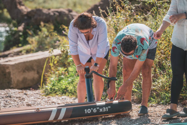 istock Preparing Inflatable Paddle Board To Go Ride In Mountain Lake 1713550173