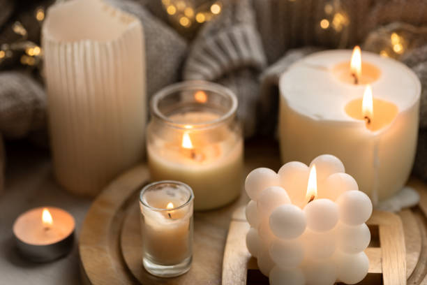 istock A cozy composition with candles, a knitted element and a garland. 1713550206