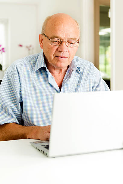 istock Senior man is typing on a laptop 171355121