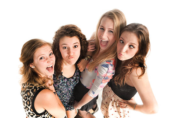 Subject: A group of young teen girls posing, making funny faces and having fun on white background.