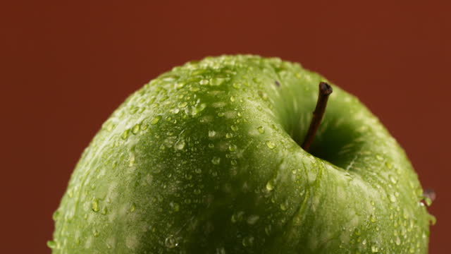 Rotating a wet apple in slow motion