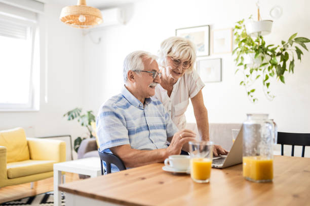 istock Mature Couple's Breakfast and Laptop 1713556896