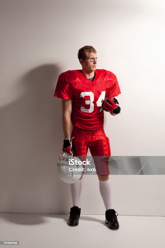 Football player standing in front of a white background Football player standing in front of a white backgroundhttp://www.twodozendesign.info/i/1.png American Football Player Stock Photo