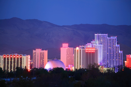 Reno Nevada downtown skyline glittering at night. Reno is a city in the US state of Nevada near Lake Tahoe. Known as 