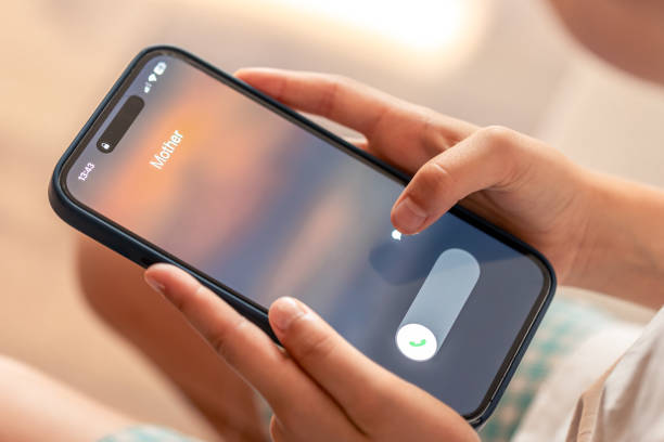 istock Smartphone in child hands with Incoming mother call on a screen. 1713558507