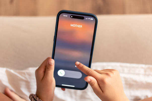 istock Smartphone in child hands with Incoming mother call on a screen. 1713558528