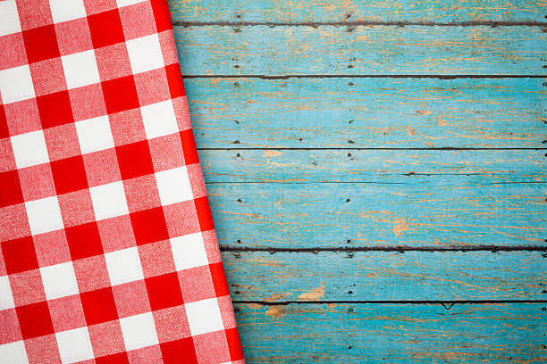 istock Red checked napkin on blue wooden picnic table 171356375