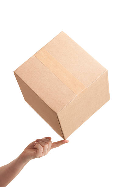 A cardboard box balancing on fingertip. Isolated on a pure white background, absolutely no dot in the white area no need to cut-out e.g. can be dropped directly on to a white web page seemlessly.