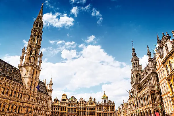 "Grand Place (Grote Markt) the heart of Brussels and and Town Hall on the left  (Hotel de Ville), Belgium. UNESCO World Heritage Site since 1998. Beautiful sunny day and cumulus clouds over the Grand Place. Visible are traditional Belgium Buildings in Brussels Central Square.See more images like this in:"