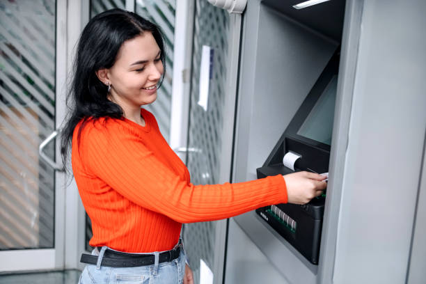 istock Young woman in front of ATM 1713565213