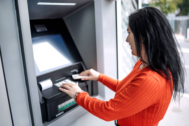 istock Young woman in front of ATM 1713565219