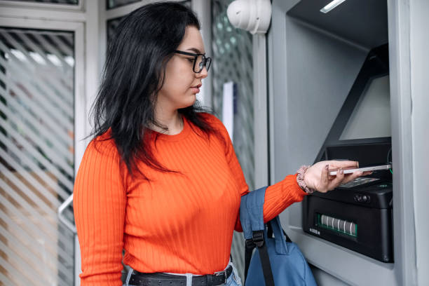 istock Young woman in front of ATM 1713565253