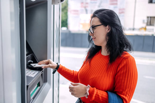 istock Young woman in front of ATM 1713565254