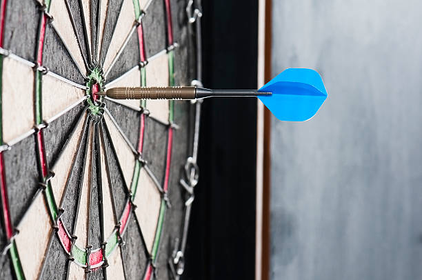 istock Dart board with a single dart in the bulls eye 171356602
