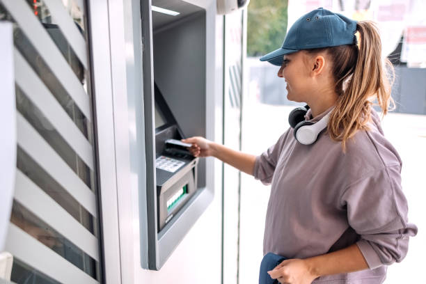 istock Young woman in front of ATM 1713566351