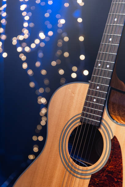 istock Close-up, acoustic guitar on a dark background with bokeh lights. 1713570171