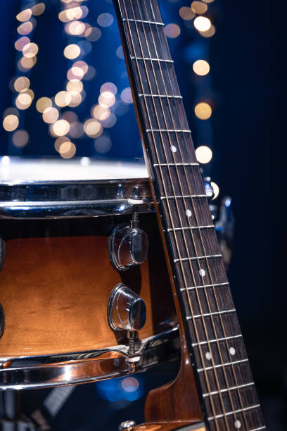 istock Snare drum and guitar on a blurry dark background with bokeh. 1713570198