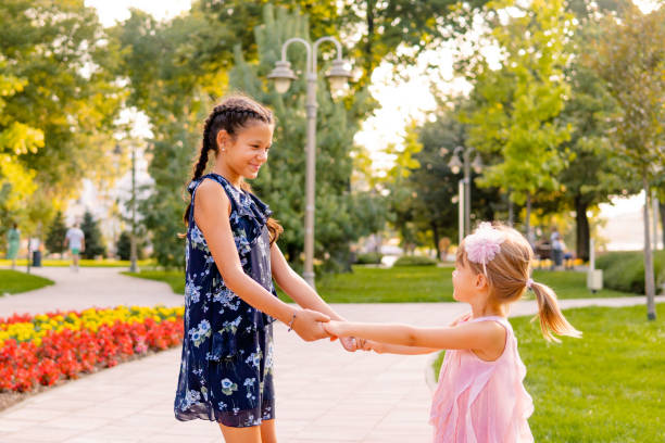 istock Two happy girls playing in the park 1713570201