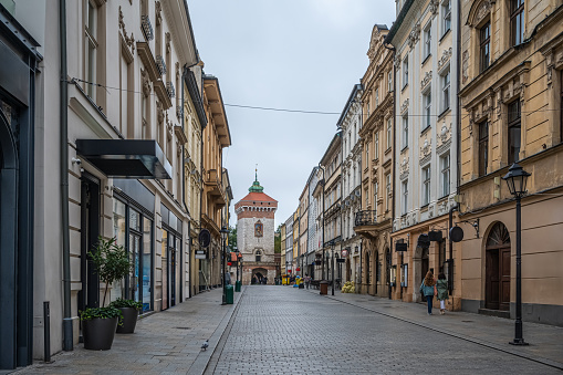 St. Florian's Gate in Krakow, Poland. Tourist street with shops, cafes