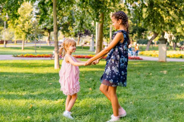 istock Two happy girls playing in the park 1713570803