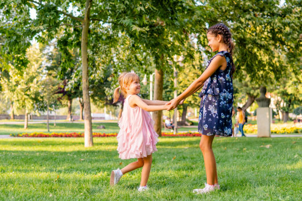 istock Two happy girls playing in the park 1713571369