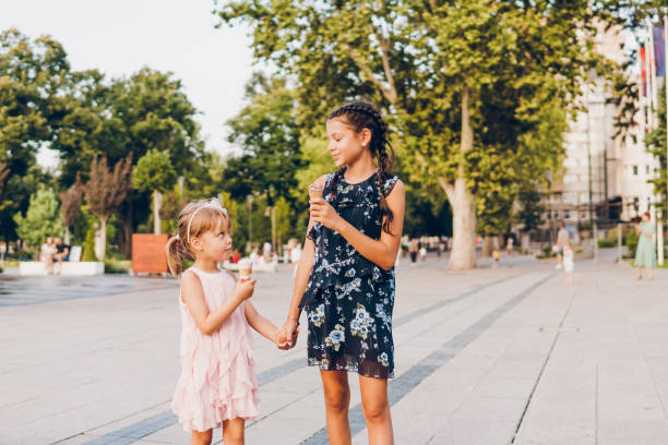 istock Two happy girls walking through the park 1713573208