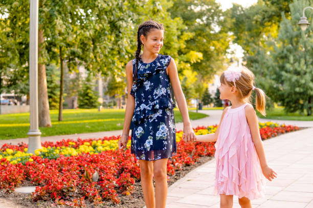 istock Two happy girls walking through the park 1713573641