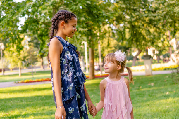 istock Two happy girls walking through the park 1713574833