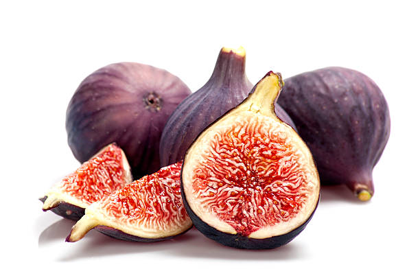 Fresh figs Sliced ripe figs on white background fig photos stock pictures, royalty-free photos & images