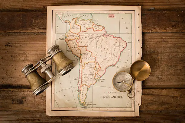 Photo of Antique 1870 Map of South America, Binoculars, and Compass