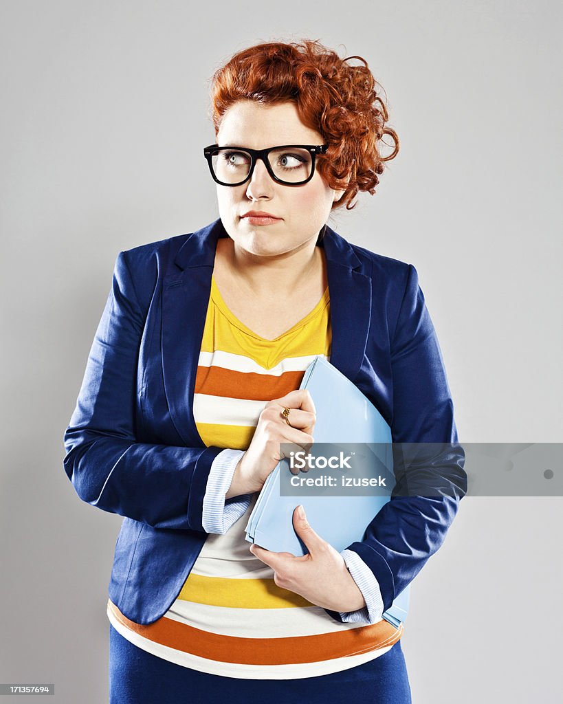 Anxiety Portrait of scared young businesswoman looking away. Studio shot, grey background. 25-29 Years Stock Photo