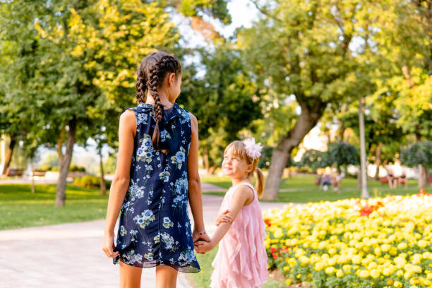 istock Two happy girls walking through the park 1713578678