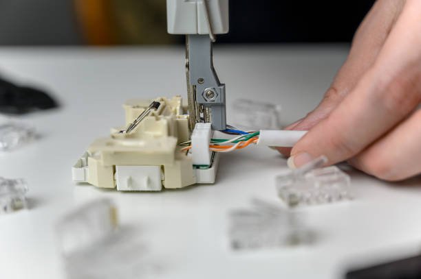 istock Manual crimping of the network cable. Installation of Internet or telephone line cables using a crimping device. 1713579821