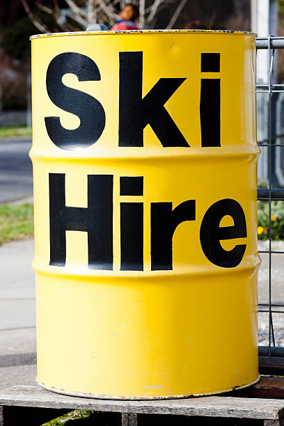 Yellow metal barrel with black sign Ski Hire