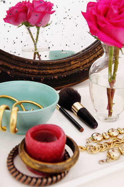 istock Vanity table with jewelry pieces and pink rose on vase 171358451