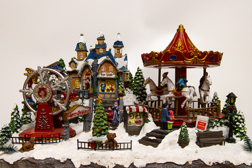 Miniature Christmas village  with carousel, toy shop and ferris wheel