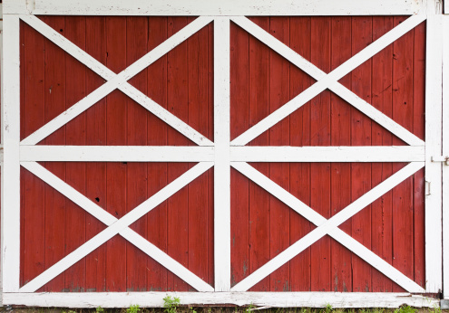 Old antique wood building exterior with door and old rusty hinges in ghost town in western USA. Useful as background.