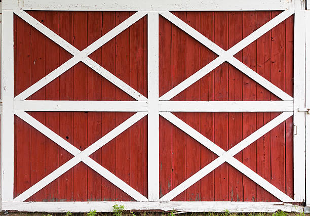 Red barn doors with white trim Weathered barn doors with white crossed trim barn doors stock pictures, royalty-free photos & images