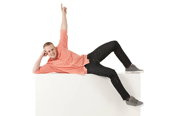 istock Happy young man lying on the ledge of a wall 171358759