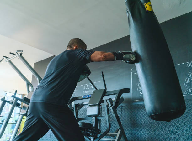 istock Man, sparring with punching bag in gym 1713591988