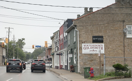 Hamilton, Canada - August 24, 2023: Traffic waits on Waterdown Road at Dundas Street in Waterdown village. Overcast morning in southwestern Ontario.