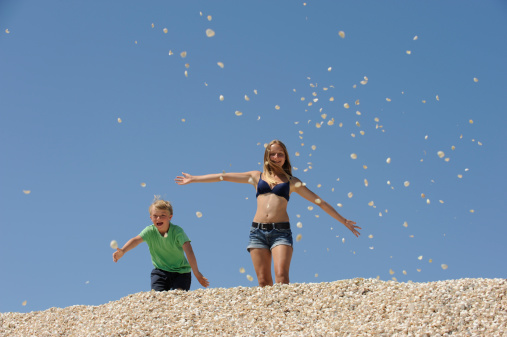 Shell Throwing Two Children Throwing Shells In The Sky Stock Photo - Download Image ...