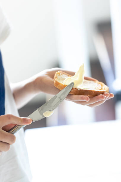 istock A piece of bread with butter in a woman's hand. 1713602622