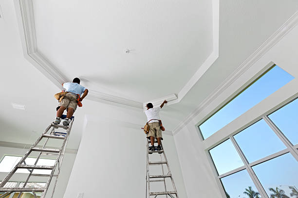 Construction: Installing crown molding carpenters installing crown moldingBuilding and Construction moulding trim photos stock pictures, royalty-free photos & images