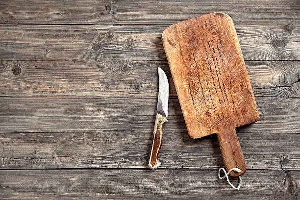 Photo of Old cutting board and knife