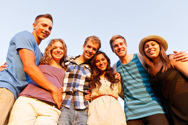 istock Looking up at six friends and blue sky 171361181