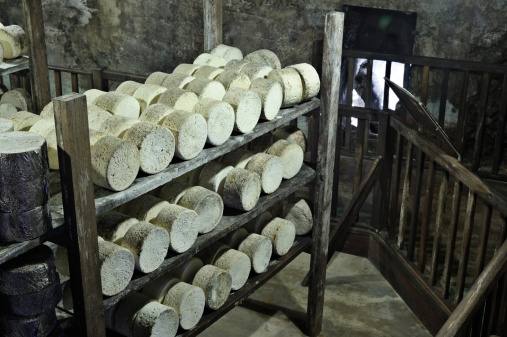 Taken in one of the famous caves at Roquefort, France. Rounds of cheese, having been injected with Penicillium roqueforti to create the blue colour and characteristic taste, then the cheese are wrapped in foil and left to mature for 3-10 months.