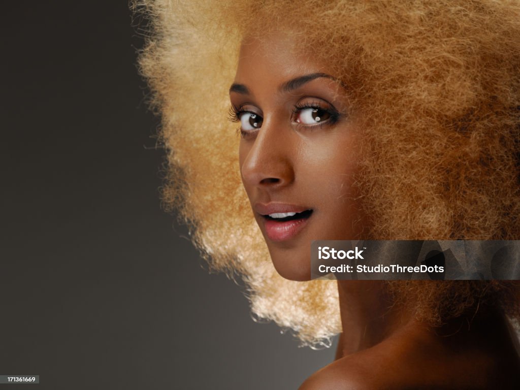 attractive young african woman with curly hair close up portrait of attractive young african woman with curly hair looking to camera Afro Hairstyle Stock Photo